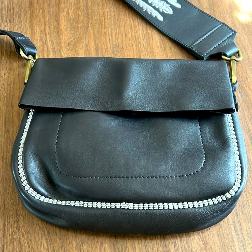 Hamimi leather saddle bag with w embroidered adjustable strap.